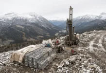 Hecla Extends Keno Hill Silver Trend with High-Grade Drill Results Drilling rig on a rocky, snow-dusted mountainside with stacked metal frames and equipment nearby.