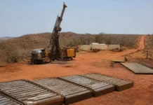 Fortuna Expands Senegal Gold Projects with $200 Million Deal Oil drilling rig on a dusty red dirt site with stacked pipes and equipment nearby.