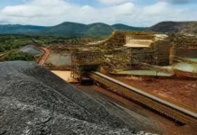 Brazil Congress Approves Critical Minerals Policy Bill Industrial coal mining site with conveyor belts and large coal piles against a hilly landscape in the background.